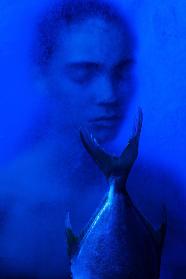 Harmony: a portrait and fish immersed in vivid blue