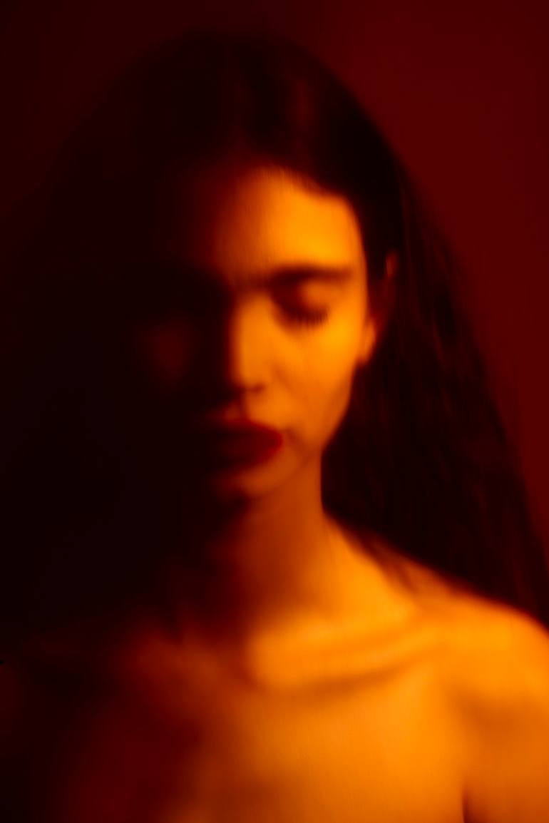 Inner Light: a softly blurred portrait illuminated in red and gold